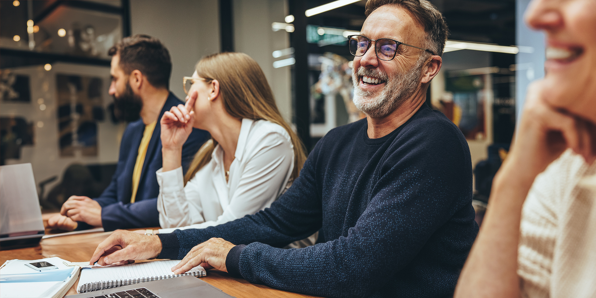 happy businessman with colleagues in a meeting